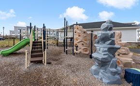 East Greenwich apartment for rent - A playground with a green slide and climbing structures.