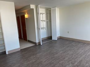Mayfield Heights apartment for rent - A room with a white wall and a grey floor with a white door.