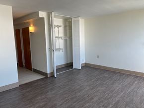 Mayfield Heights apartment for rent - A room with a white wall and a wooden floor.