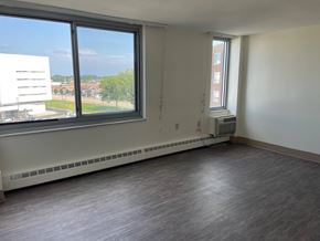 Mayfield Heights apartment for rent - A room with a window overlooking a parking lot.