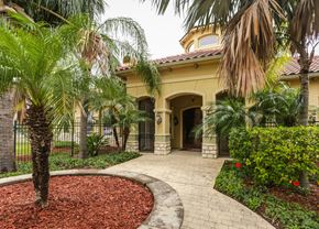 Mission apartment for rent - A house with a red roof and a palm tree in front.
