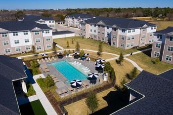 An aerial view of the resort style pool and courtyard