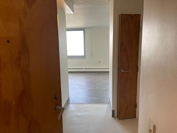 Mayfield Heights apartment for rent - A hallway with a wooden door on the left and a wooden door on the right.