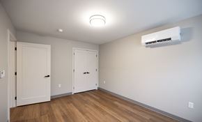 Mechanicville apartment for rent - A room with a white ceiling, a white air conditioner, and three white doors at Hudson Heights Apartments, Mechanicville, NY
