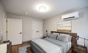 Mechanicville apartment for rent - A bedroom with a large bed and a wooden headboard.