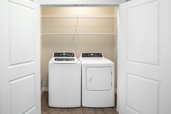 A washer and dryer in a laundry room with white doors
