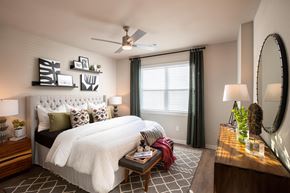 Houston apartment for rent - a bedroom with a large white bed and green curtains at 55 Fifty at Northwest Crossing, Houston, 77092