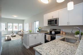 Hartford townhouse for rent - A kitchen with granite countertops and white cabinets.
