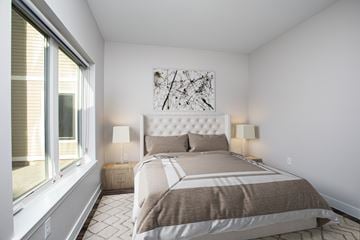 Hartford townhouse for rent - A bedroom with a large bed and a painting on the wall.