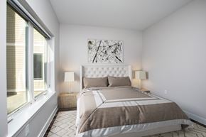 Hartford townhouse for rent - A bedroom with a large bed and a painting on the wall at MLK Apartments, Hartford, 06106