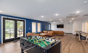 Hartford townhouse for rent - A foosball table is in the middle of a room with a couch and a pool table.