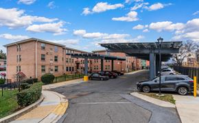 Washington apartment for rent - A parking lot with cars and a building in the background.