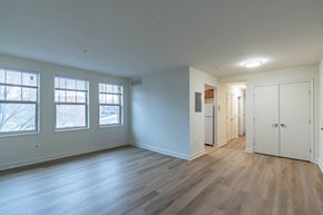 Washington apartment for rent - A room with wooden floors and white walls.