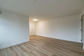 Washington apartment for rent - A room with wooden flooring and a door on the left side.