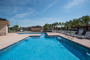 Mcallen apartment for rent - our resort style swimming pool is next to our club house with palm trees
