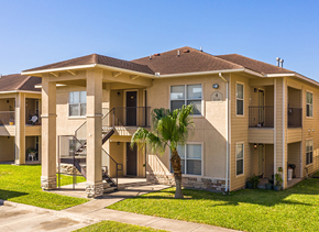 Mcallen apartment for rent - an apartment building with a palm tree in the yard