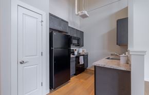 Uncasville apartment for rent - A kitchen with a black fridge and microwave.