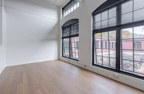 Uncasville apartment for rent - A room with a large window and wooden flooring.