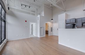 Uncasville apartment for rent - A large, empty room with wooden floors and white walls.