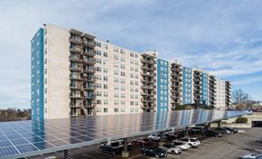 Washington apartment for rent - A large building with a parking lot in front of it.