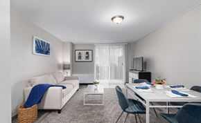 Washington apartment for rent - A living room with a couch, a dining table, and chairs.