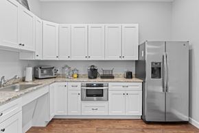 Haverhill apartment for rent - A kitchen with white cabinets and stainless steel appliances.