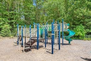 Haverhill apartment for rent - A playground with a green slide and a blue and white structure.