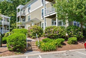 Tyngsborough apartment for rent - A building with a green lawn in front.