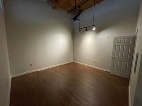 Hartford apartment for rent - an empty living room with wooden floors and a ceiling fan
