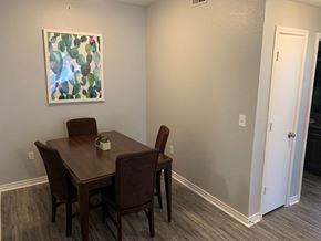 San Antonio apartment for rent - Dining area with wood table and cactus artwork at Port Royal Apartments Homes, San Antonio, 78242