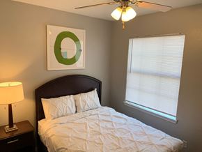 San Antonio apartment for rent - Guest bedroom with white bedding and window blinds at Port Royal Apartments Homes, San Antonio