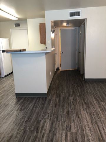 Mission apartment for rent - A kitchen with a white counter and a refrigerator.
