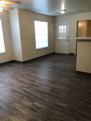 Mission apartment for rent - A room with wood flooring and a white door.