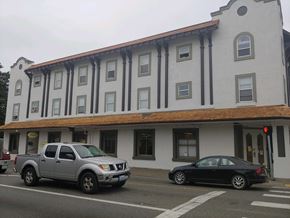 Shelton apartment for rent - a building with a brown and white facade and a black car parked in front of it