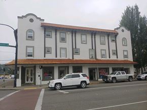 Shelton apartment for rent - a building on the corner of a street with cars parked in front of it