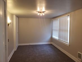 Tacoma apartment for rent - a living room with a large window and a ceiling fan