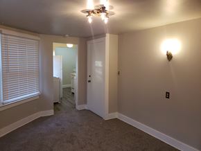 Tacoma apartment for rent - a bedroom with a ceiling fan and a door to a bathroom