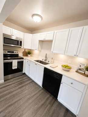 Lakewood apartment for rent - A modern kitchen with white cabinets and a black dishwasher.
