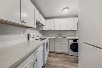 Lakewood apartment for rent - A kitchen with white cabinets and appliances.