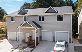 Tumwater townhouse for rent - A house with a grey roof and a car parked in front.