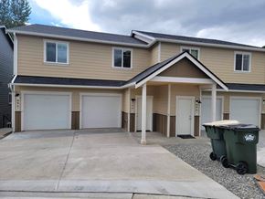 Tumwater townhouse for rent - A two-story house with a garage and a driveway.