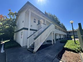 Lakewood apartment for rent - A white building with a staircase leading to the entrance.