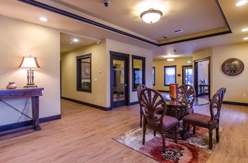 Olympia apartment for rent - A living room with a fireplace and a table with chairs.