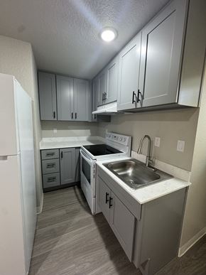 Seattle apartment for rent - A kitchen with white appliances and cabinets.