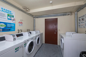 Seattle apartment for rent - A laundromat with a sign that says "Easier Laundry" and a row of washing machines.