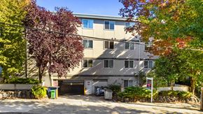 Seattle apartment for rent - A building with a garage door and a sign that says "No Parking" in front of it.