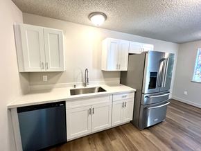 University Place apartment for rent - 2-bedroom kitchen at Bridgeport Terrace Apartments with white cabinets, white quartz countertops, and stainless steel appliances