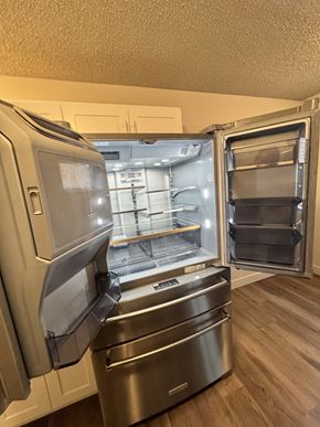 University Place apartment for rent - A stainless steel refrigerator in 2-bedroom apartment kitchen at Bridgeport Terrace Apartments.