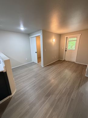 Seattle apartment for rent - A room with light brown flooring and white walls.