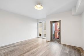 Seattle apartment for rent - A room with a sliding glass door and a wooden floor.